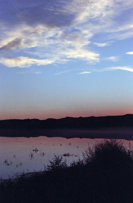 sunset silhouette river reflection clouds